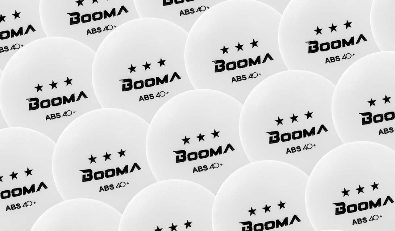 Image of a close up of BOOMA's ABS 40+ white ping pong balls.