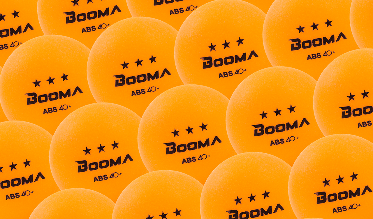 Image of a close up of BOOMA's ABS 40+ orange ping pong balls.