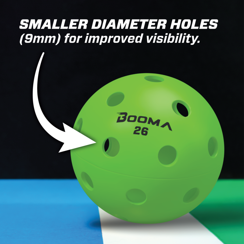 Close-up of a green BOOMA 26 indoor pickleball ball with an arrow hightlighting the smaller holes.