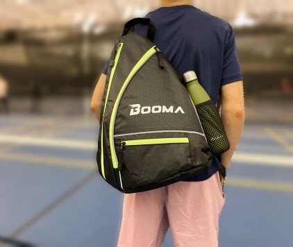 Booma pickleball sling bag on the back of a peson,